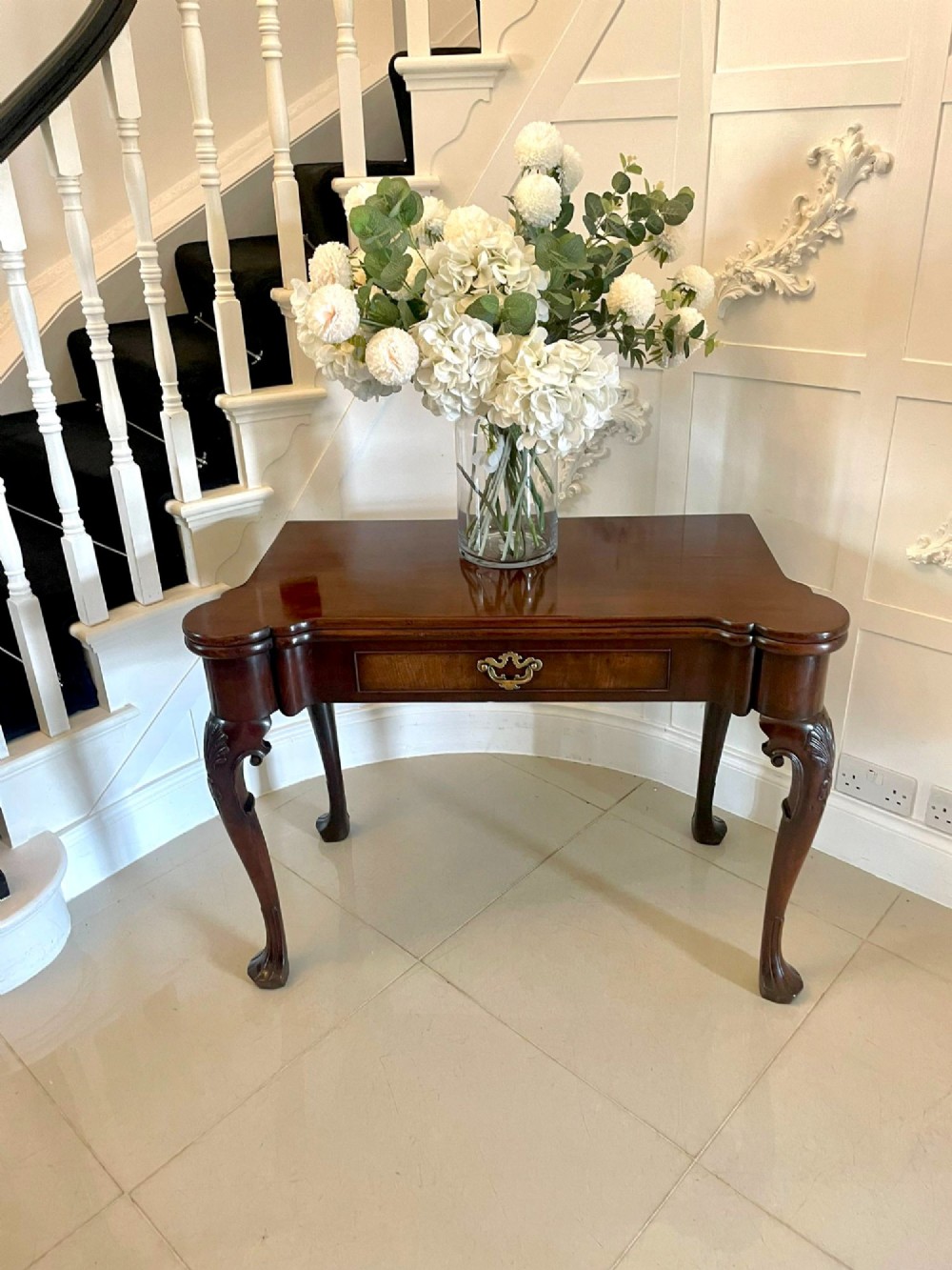An 18th-century George II mahogany fold-over card table with carved cabriole legs, shell knees, and a central frieze drawer. View VI
