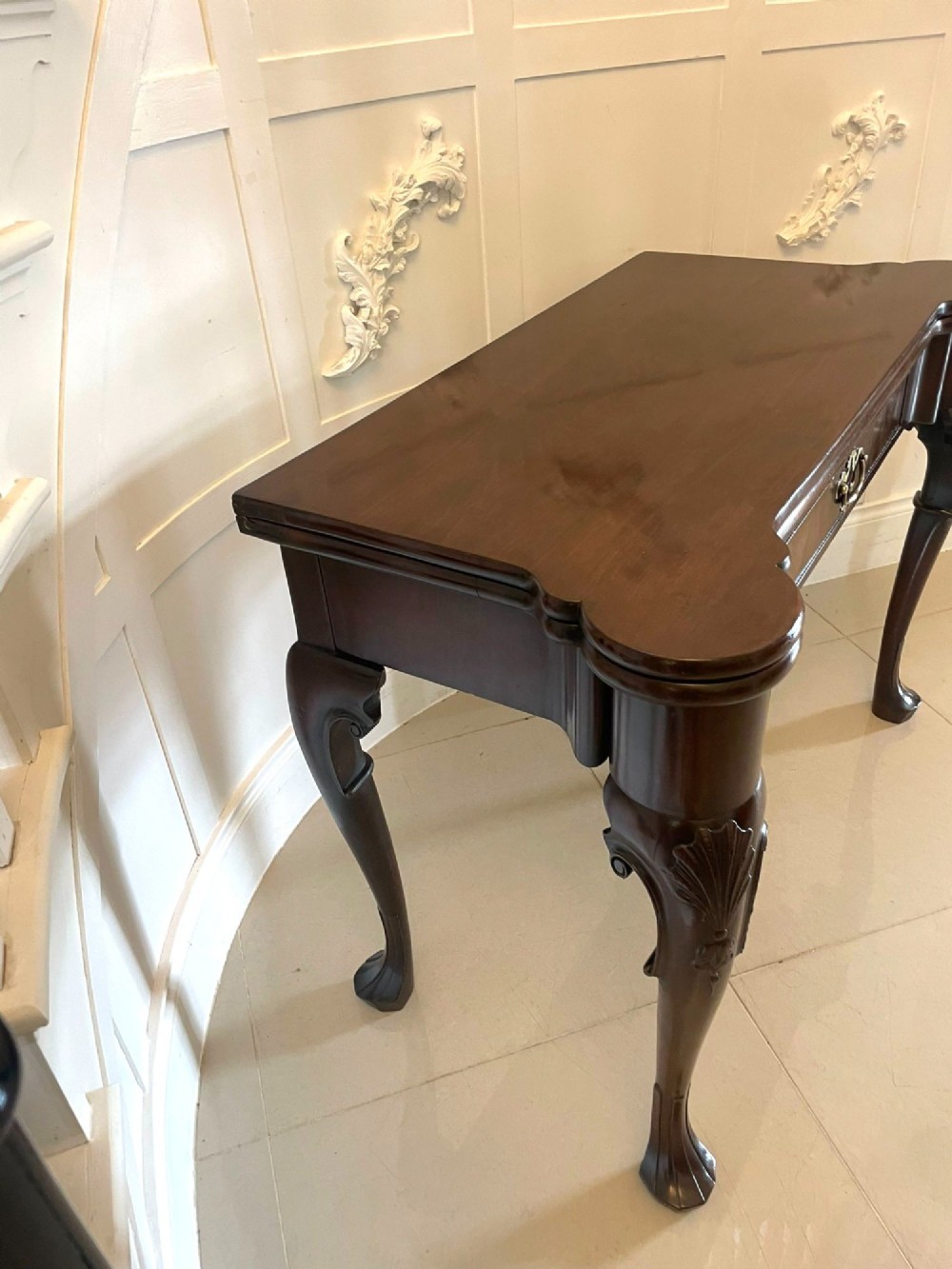 An 18th-century George II mahogany fold-over card table with carved cabriole legs, shell knees, and a central frieze drawer. View VII