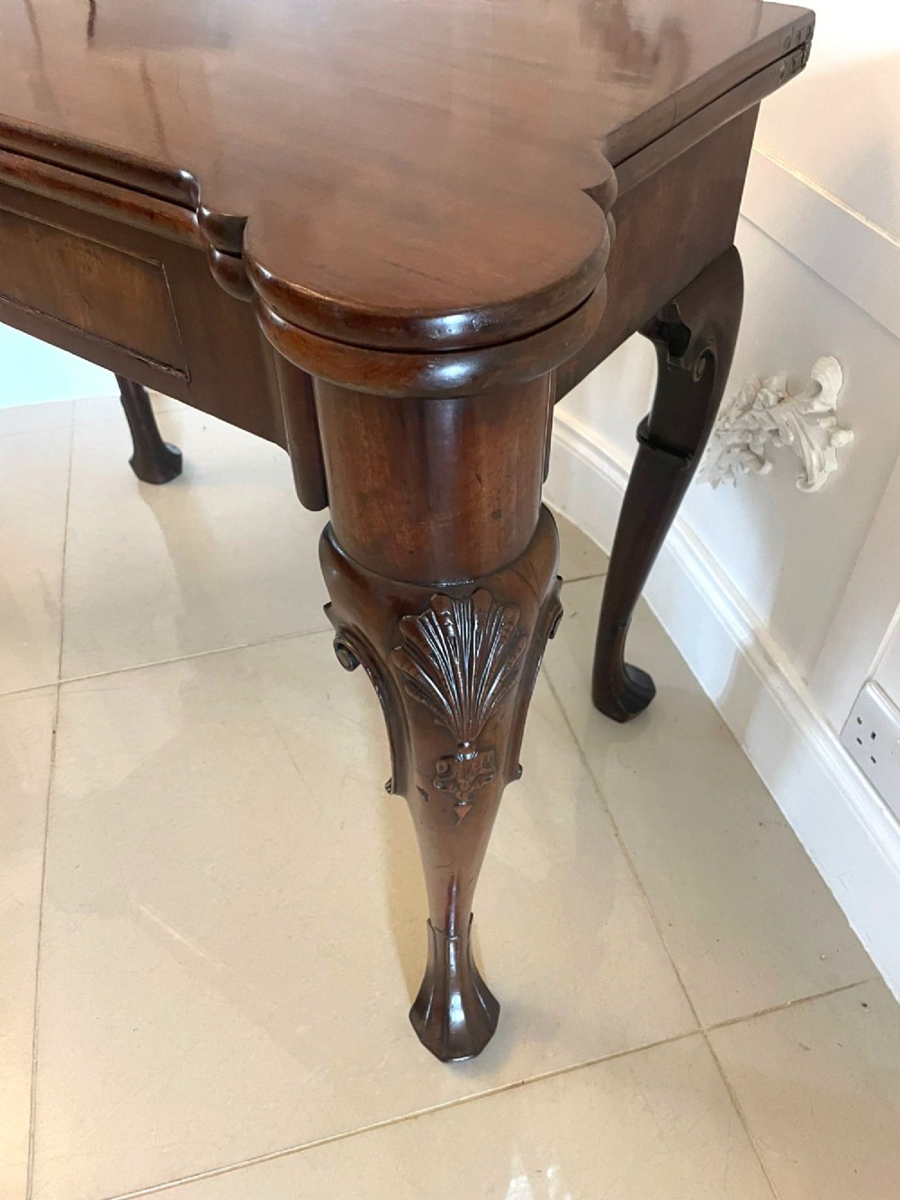 An 18th-century George II mahogany fold-over card table with carved cabriole legs, shell knees, and a central frieze drawer. View XIII