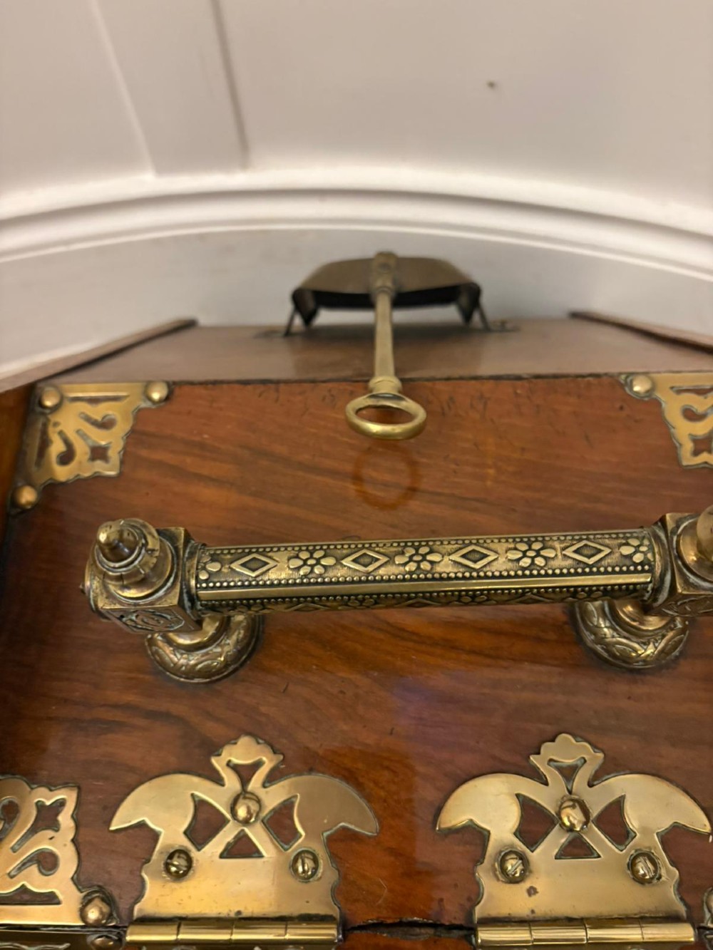 A Victorian walnut coal purdonium featuring ornate decorative brass strap hinges, brass corner plates, and a top carrying handle. View II