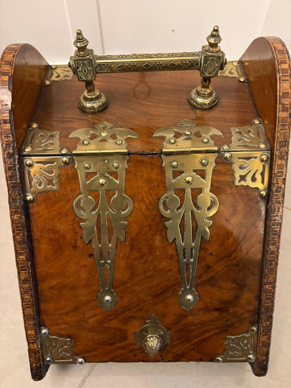 A Victorian walnut coal purdonium featuring ornate decorative brass strap hinges, brass corner plates, and a top carrying handle. View VI