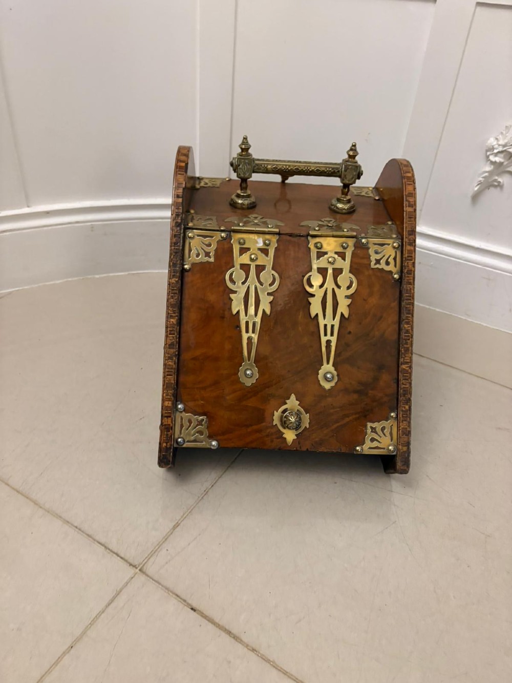 A Victorian walnut coal purdonium featuring ornate decorative brass strap hinges, brass corner plates, and a top carrying handle.