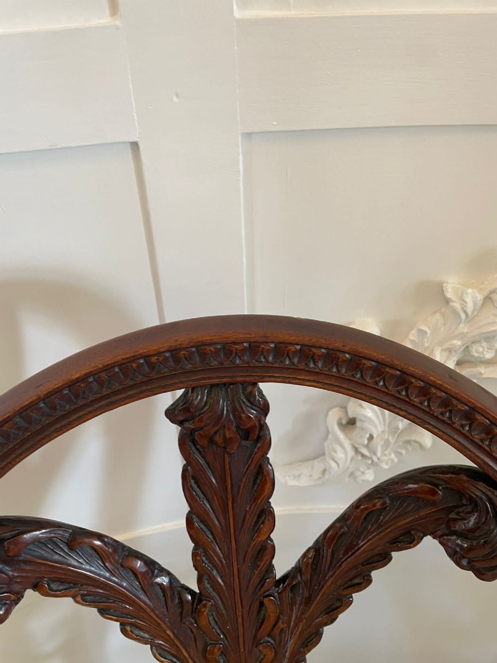 A pair of carved mahogany open armchairs featuring oval backs with carved splats, padded armrests, and pale green patterned fabric seats on fluted front legs. View VII