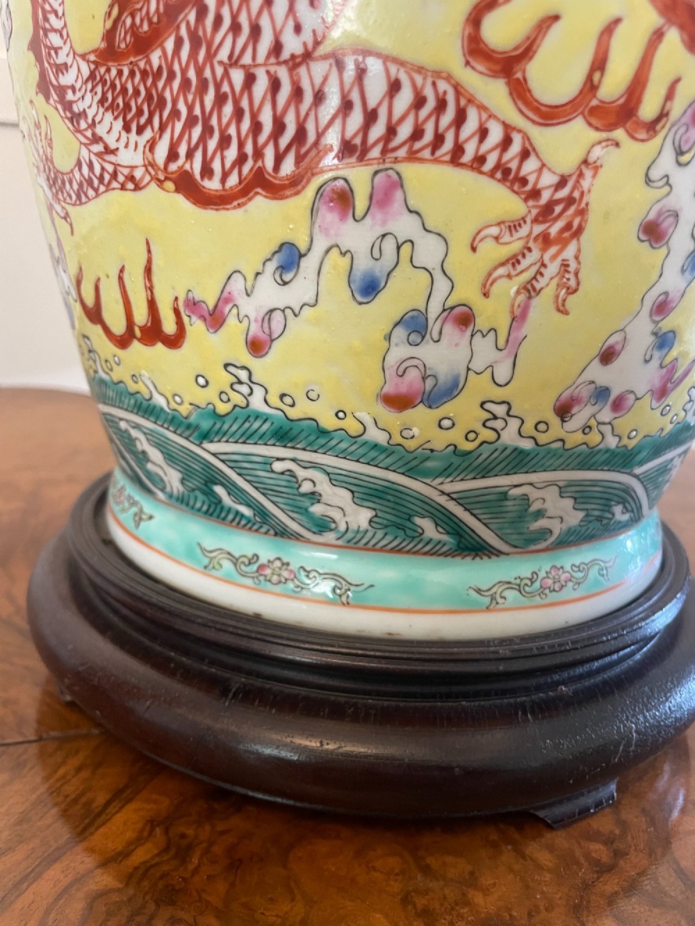 A pair of large 19th-century Chinese porcelain vase lamps featuring hand-painted dragons on a yellow ground, set on dark wooden bases. View VII