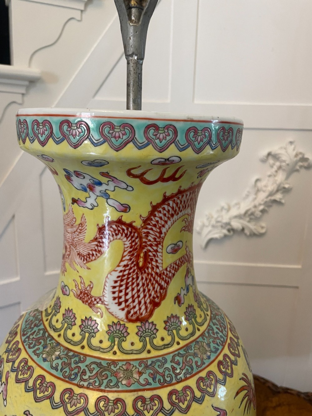 A pair of large 19th-century Chinese porcelain vase lamps featuring hand-painted dragons on a yellow ground, set on dark wooden bases. View VIII