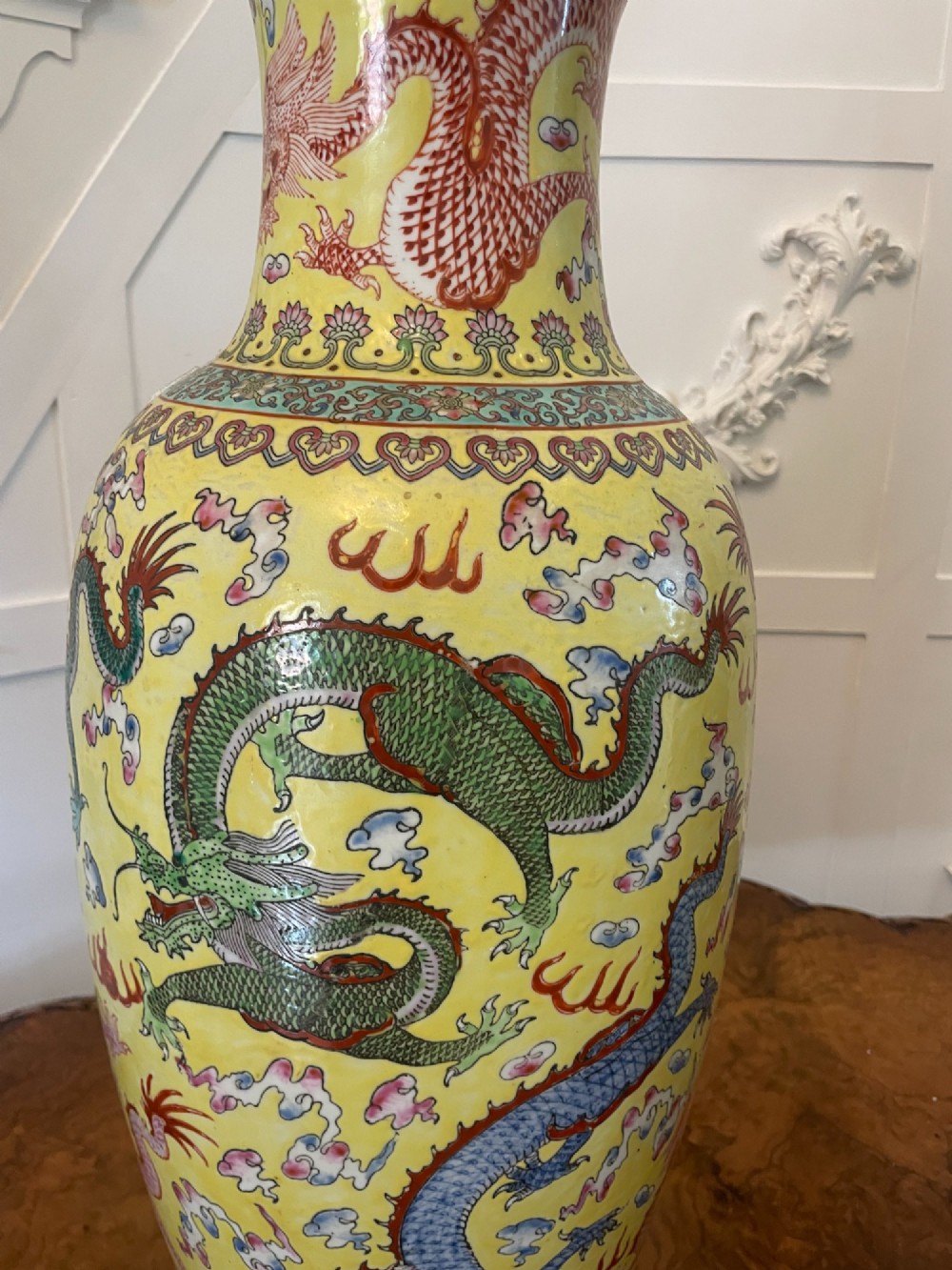 A pair of large 19th-century Chinese porcelain vase lamps featuring hand-painted dragons on a yellow ground, set on dark wooden bases. View IX