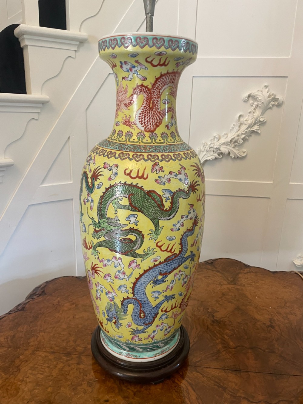A pair of large 19th-century Chinese porcelain vase lamps featuring hand-painted dragons on a yellow ground, set on dark wooden bases. View X