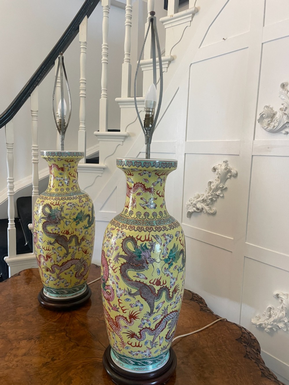 A pair of large 19th-century Chinese porcelain vase lamps featuring hand-painted dragons on a yellow ground, set on dark wooden bases. View XIV