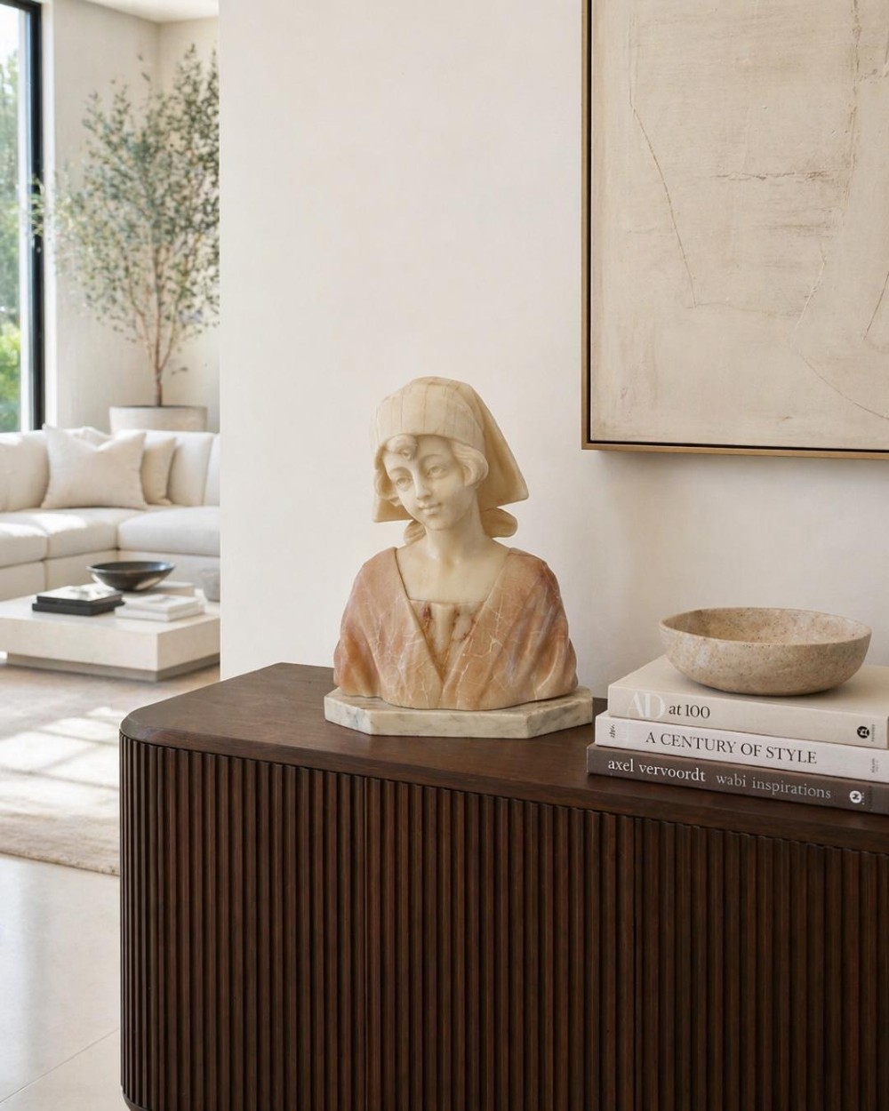 Carved Victorian alabaster bust depicting a young woman wearing a traditional bonnet, mounted on an octagonal marble base. View II