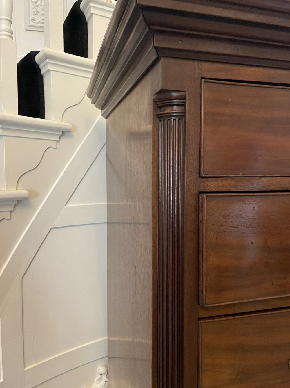 A tall George III mahogany chest on chest featuring two short over six long drawers with brass swan-neck handles and ogee bracket feet. View III