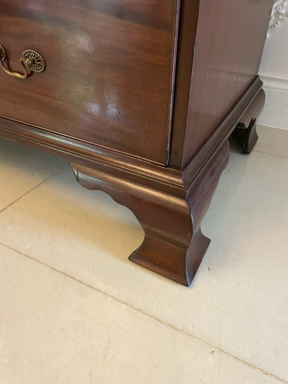A tall George III mahogany chest on chest featuring two short over six long drawers with brass swan-neck handles and ogee bracket feet. View V