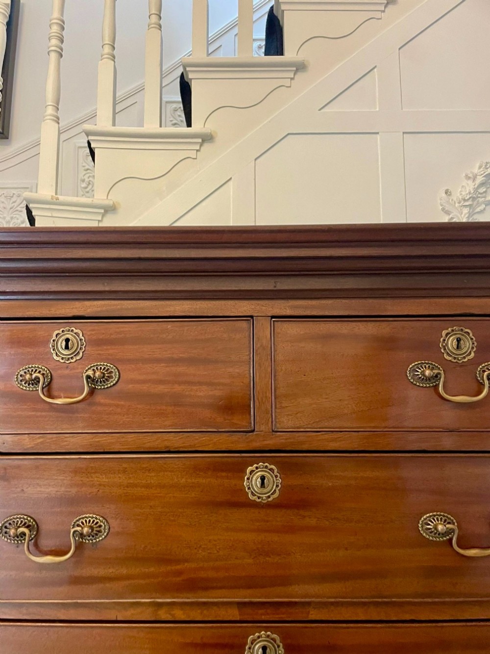 A tall George III mahogany chest on chest featuring two short over six long drawers with brass swan-neck handles and ogee bracket feet. View VII