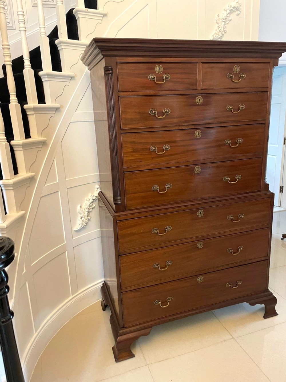 A tall George III mahogany chest on chest featuring two short over six long drawers with brass swan-neck handles and ogee bracket feet. View IX
