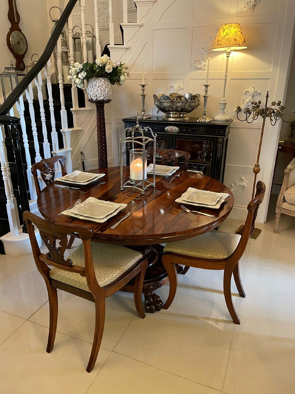 An antique William IV circular rosewood tilt-top table featuring prominent book-matched grain atop a central pedestal base with carved claw feet. View VIII