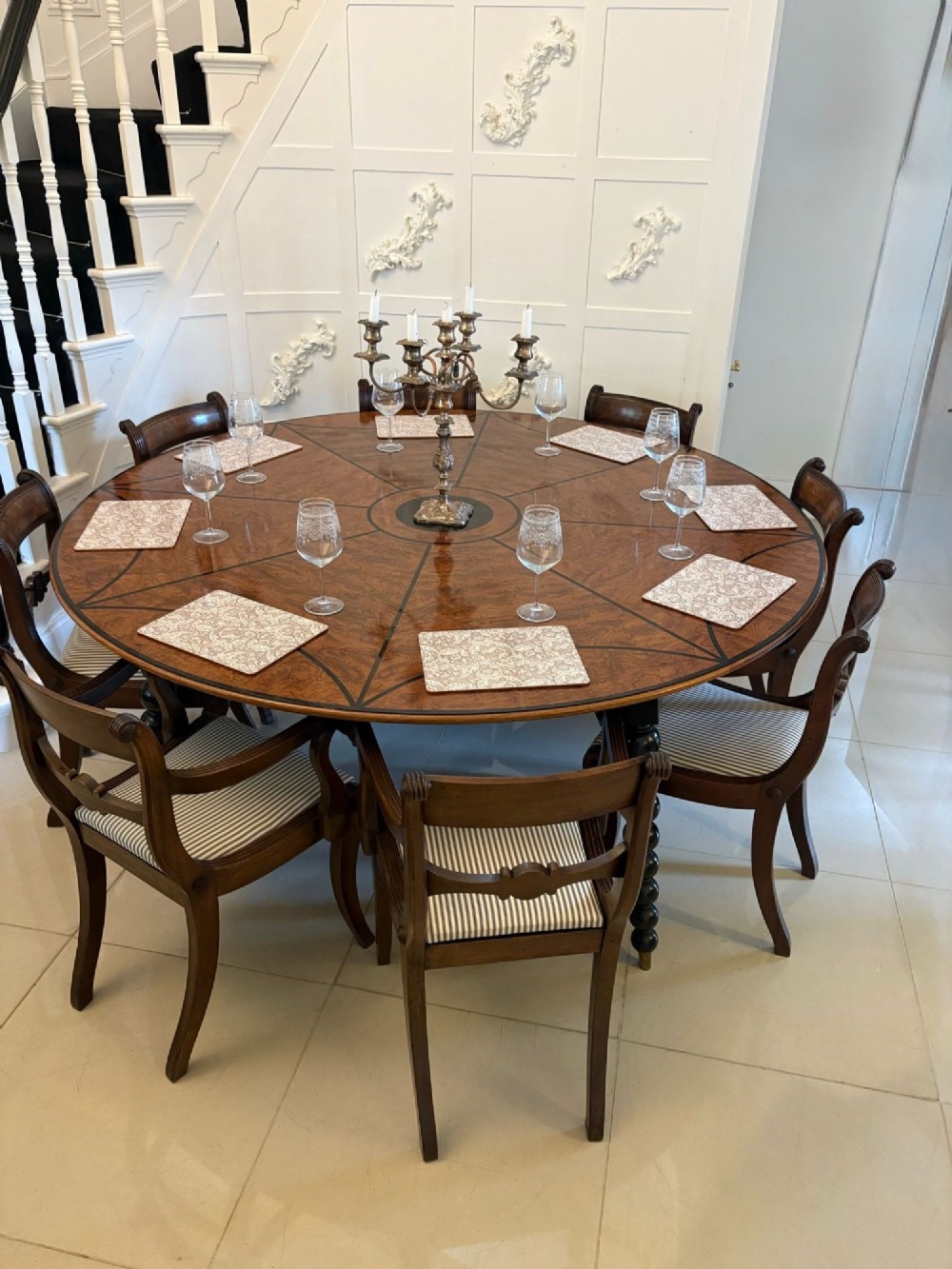 A large circular dining table crafted from burr pollard oak with geometric ebony inlay and ebonised bobbin legs. View II