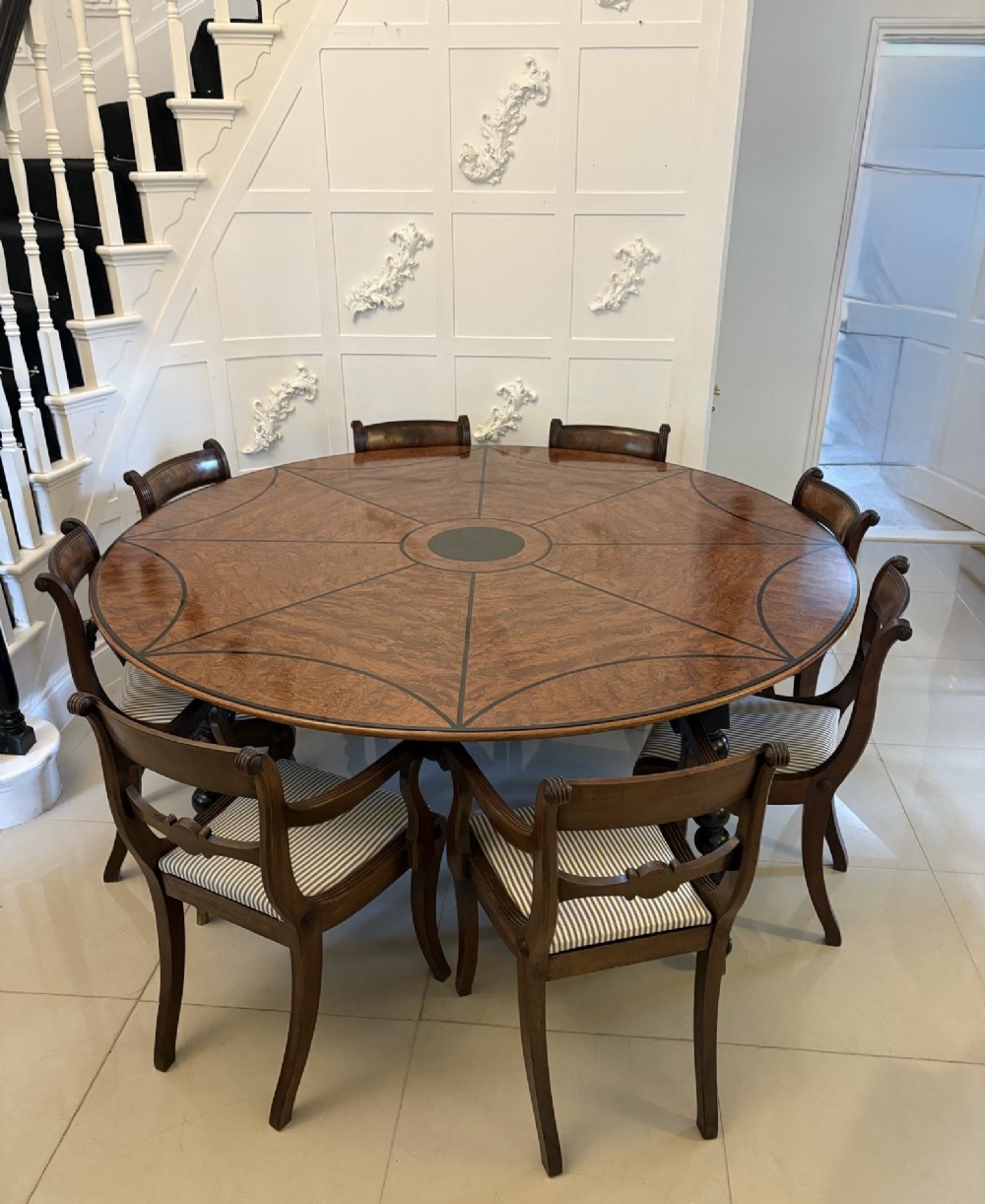 A large circular dining table crafted from burr pollard oak with geometric ebony inlay and ebonised bobbin legs. View III