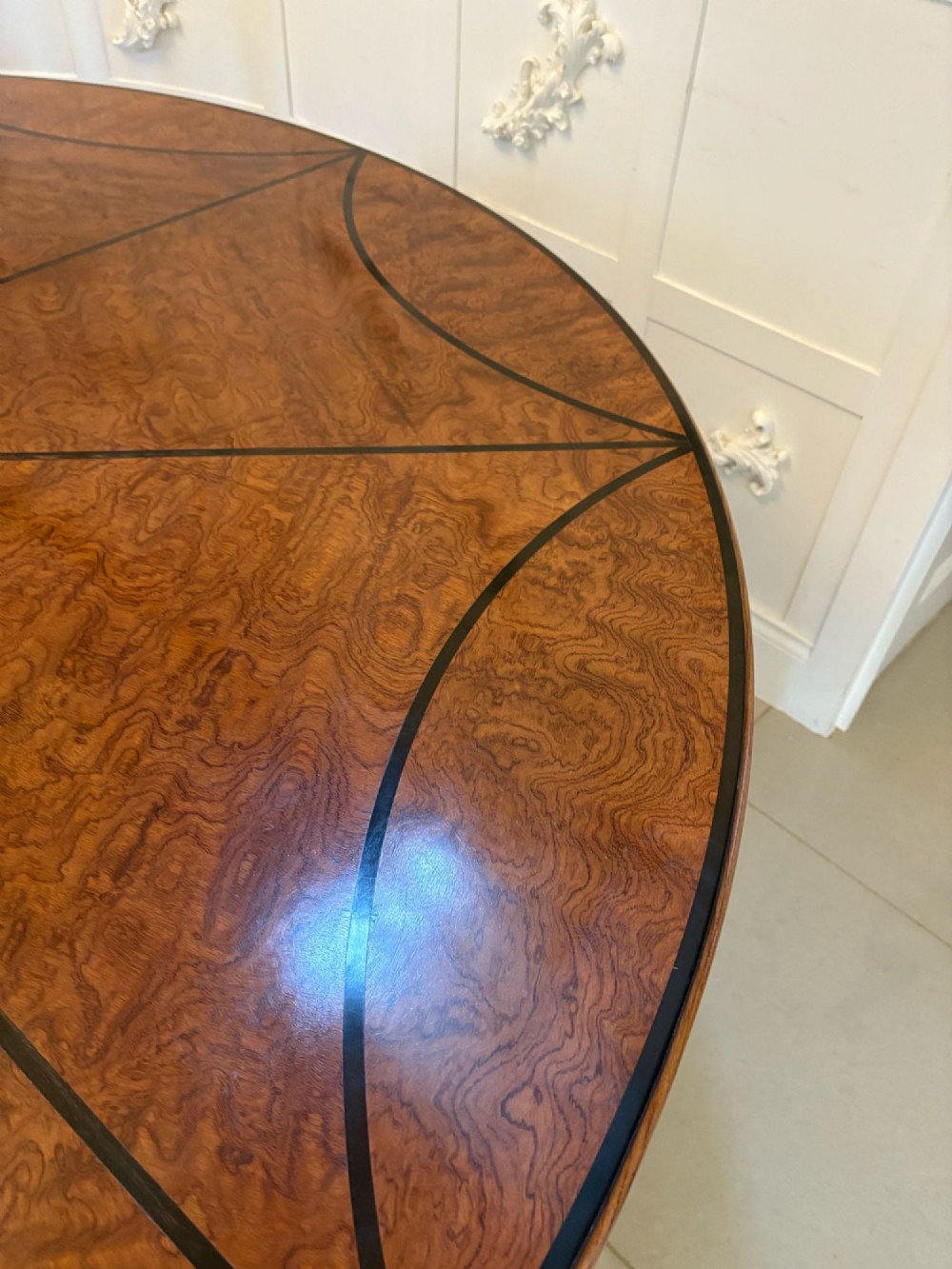 A large circular dining table crafted from burr pollard oak with geometric ebony inlay and ebonised bobbin legs. View VIII