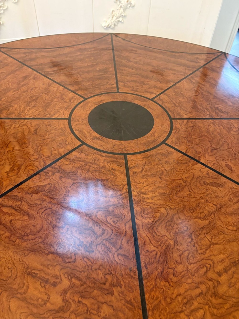 A large circular dining table crafted from burr pollard oak with geometric ebony inlay and ebonised bobbin legs. View XII