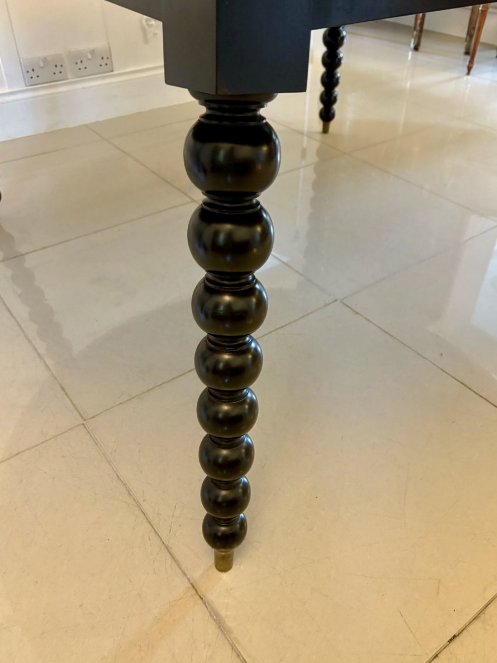 A large circular dining table crafted from burr pollard oak with geometric ebony inlay and ebonised bobbin legs. View XIII