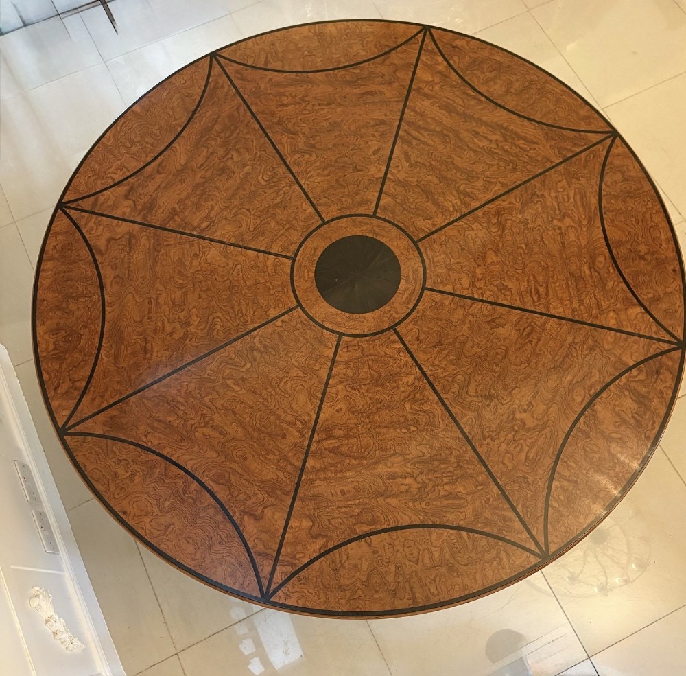 A large circular dining table crafted from burr pollard oak with geometric ebony inlay and ebonised bobbin legs. View XIV