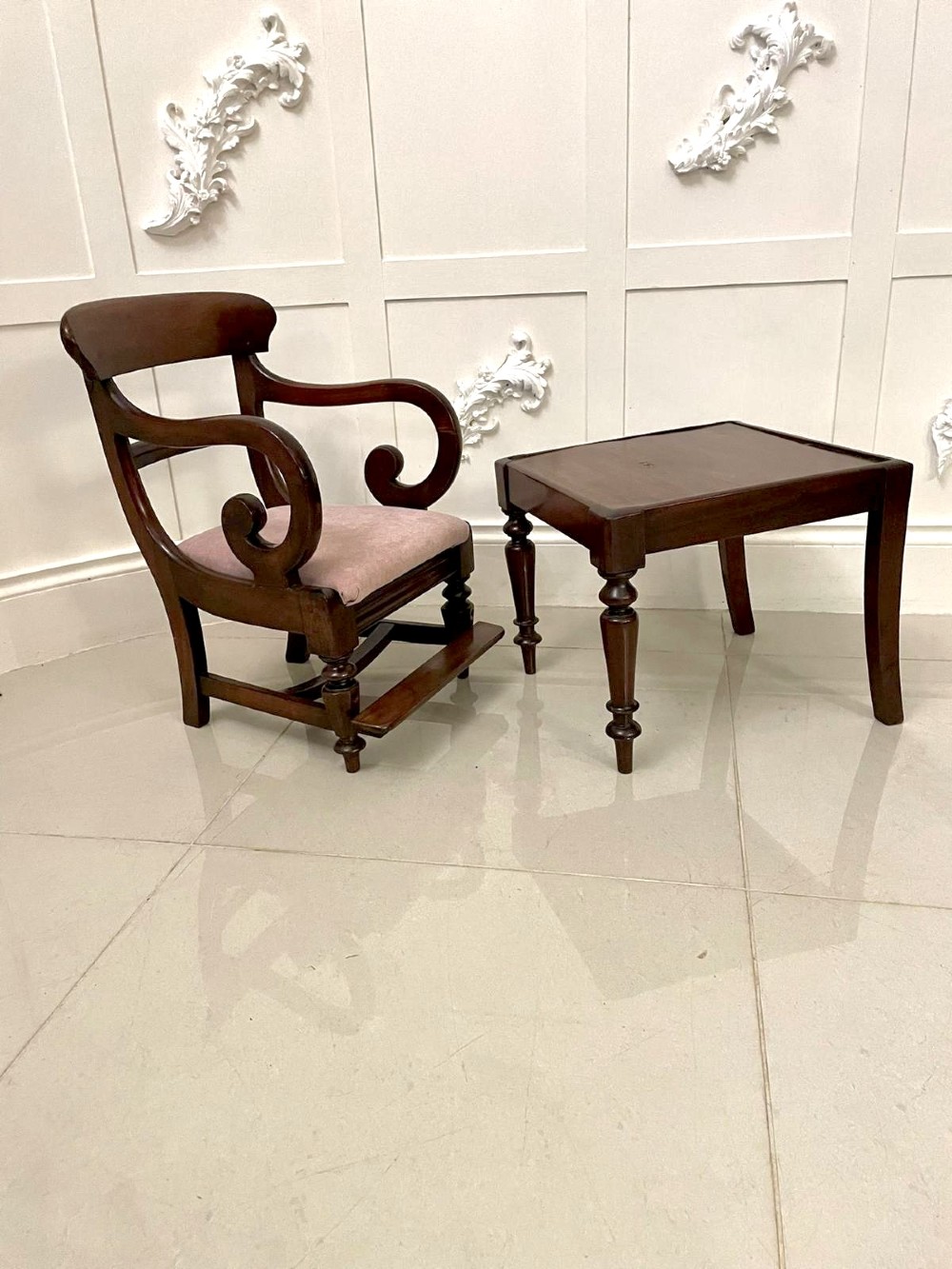 A William IV mahogany childs armchair with scroll arms and a pink upholstered seat, resting on a matching wooden conversion stand. View II