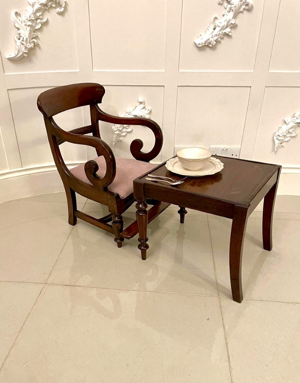 A William IV mahogany childs armchair with scroll arms and a pink upholstered seat, resting on a matching wooden conversion stand. View VI