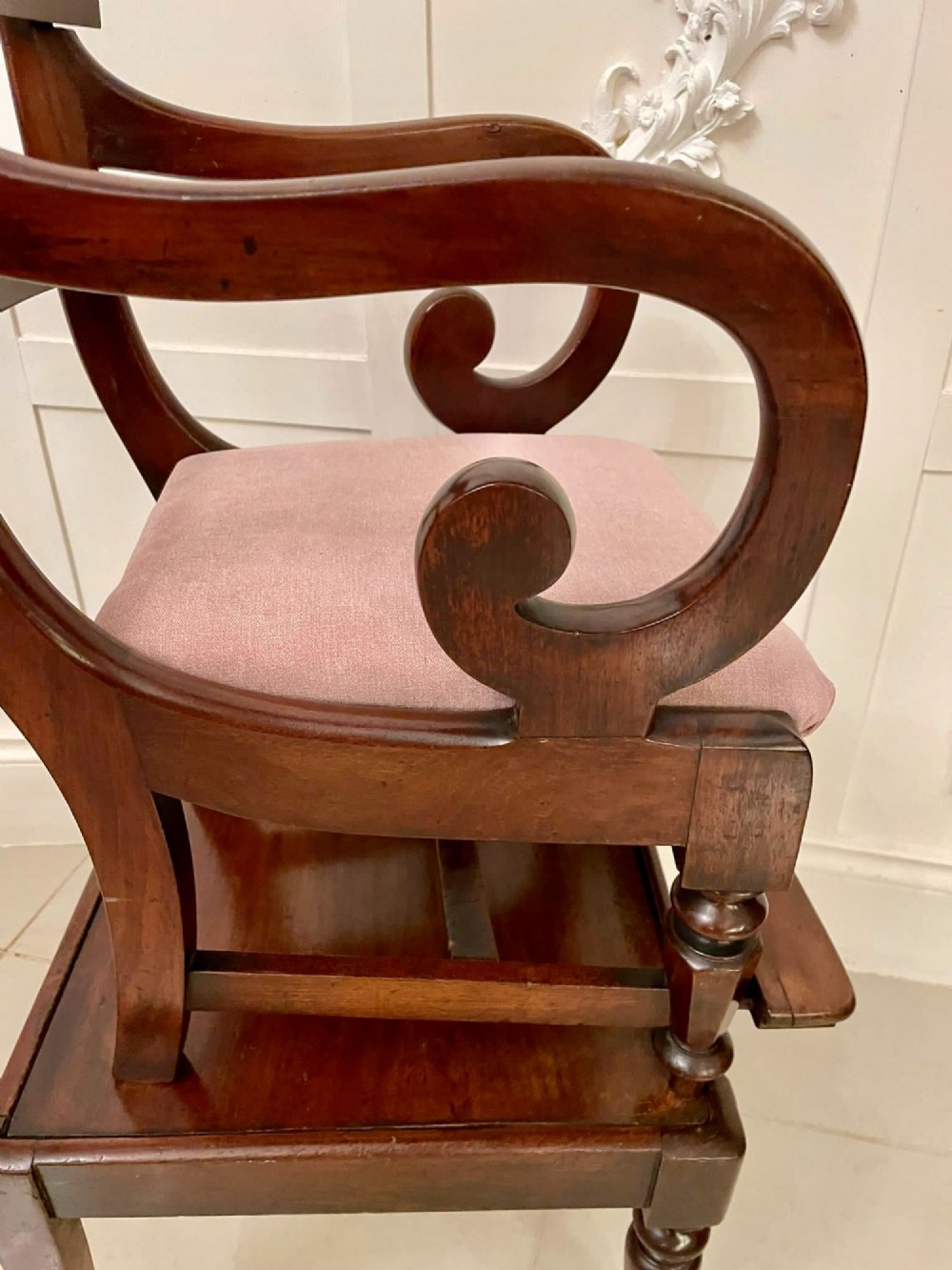 A William IV mahogany childs armchair with scroll arms and a pink upholstered seat, resting on a matching wooden conversion stand. View VIII