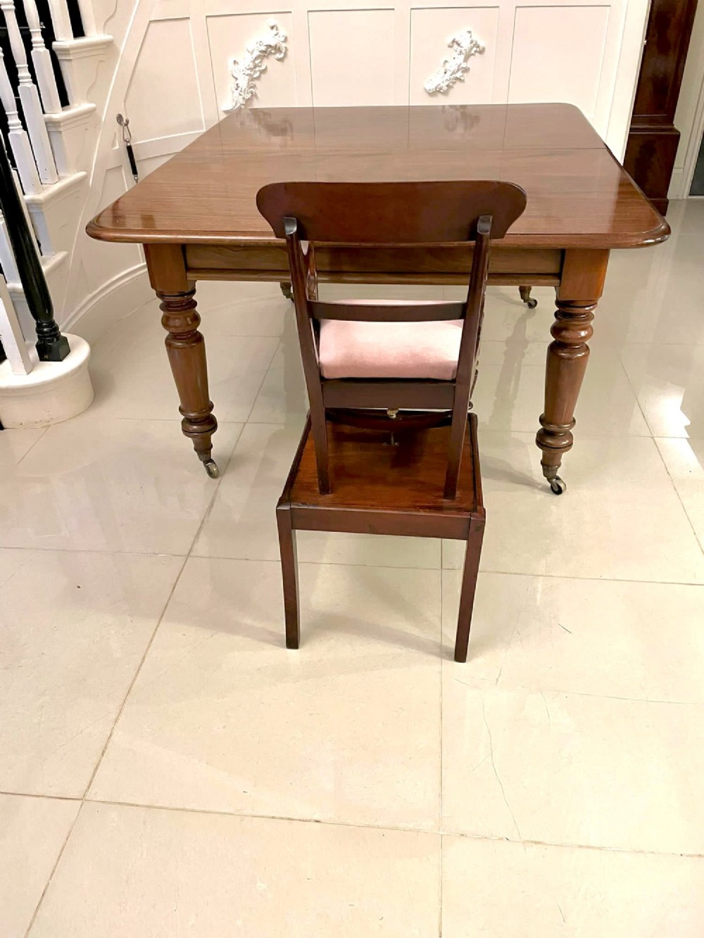 A William IV mahogany childs armchair with scroll arms and a pink upholstered seat, resting on a matching wooden conversion stand. View XI