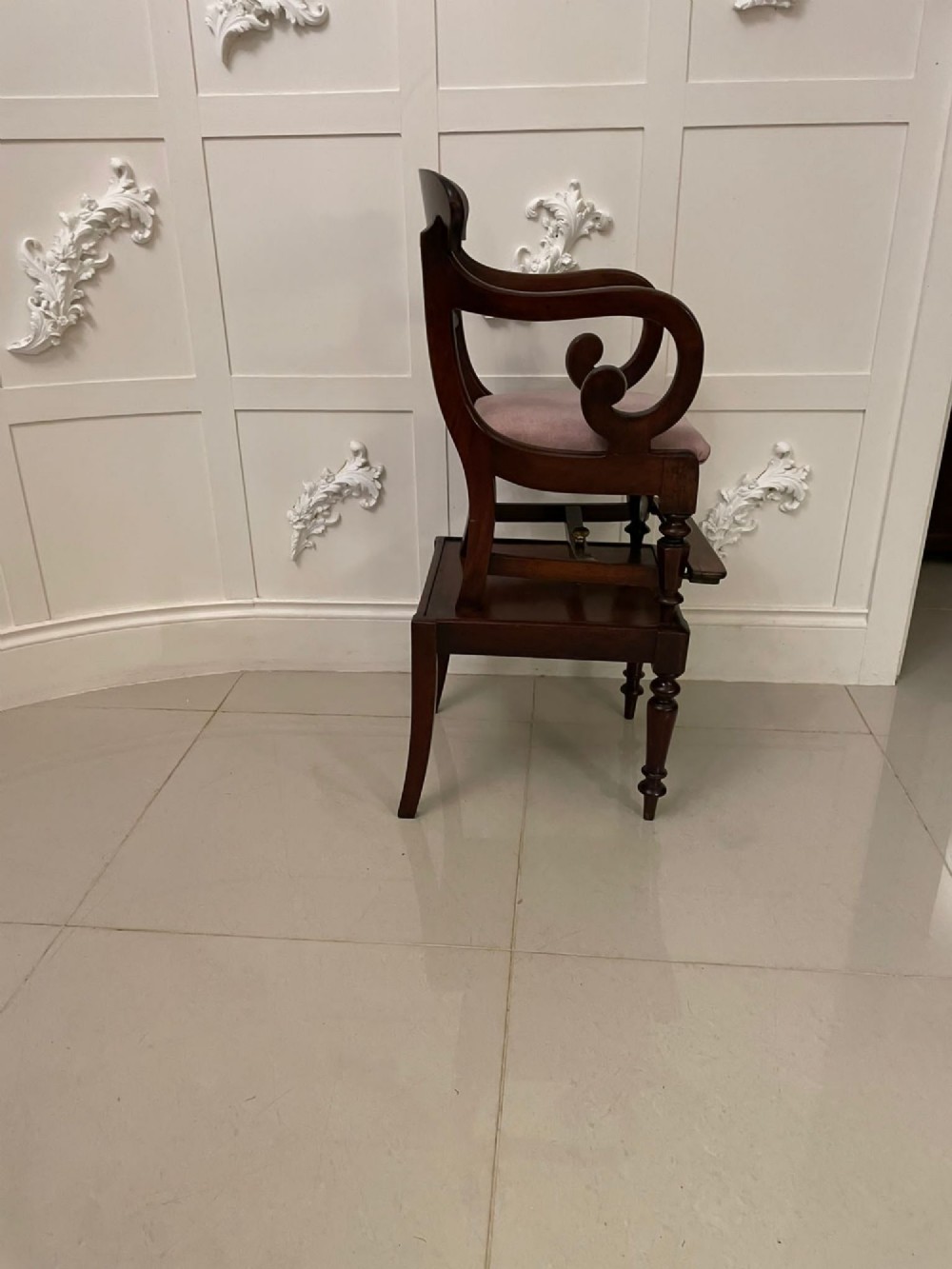 A William IV mahogany childs armchair with scroll arms and a pink upholstered seat, resting on a matching wooden conversion stand. View XII