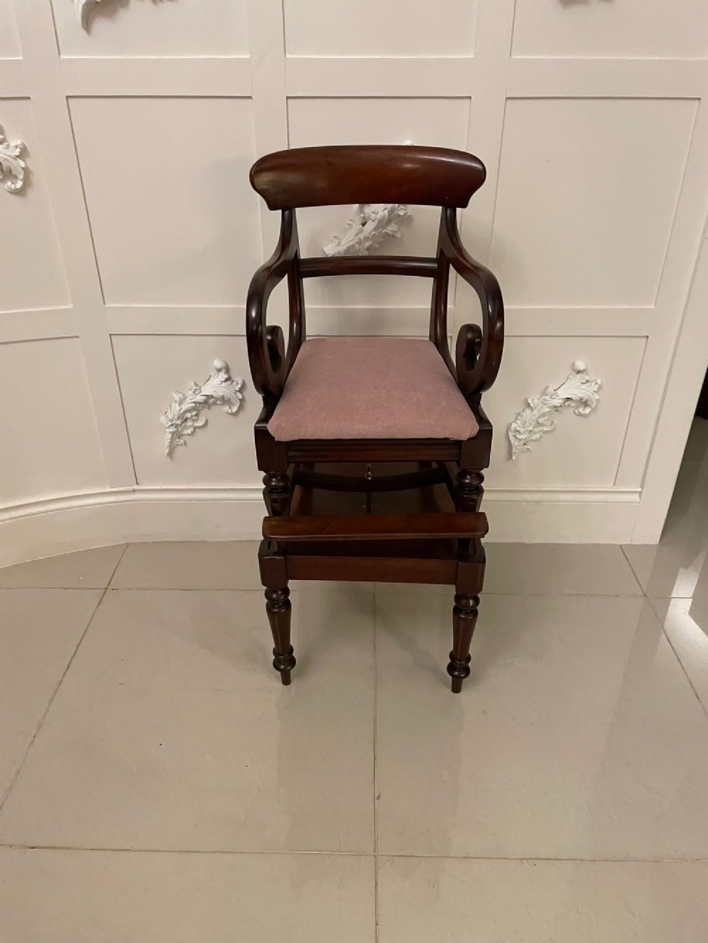 A William IV mahogany childs armchair with scroll arms and a pink upholstered seat, resting on a matching wooden conversion stand. View XIII