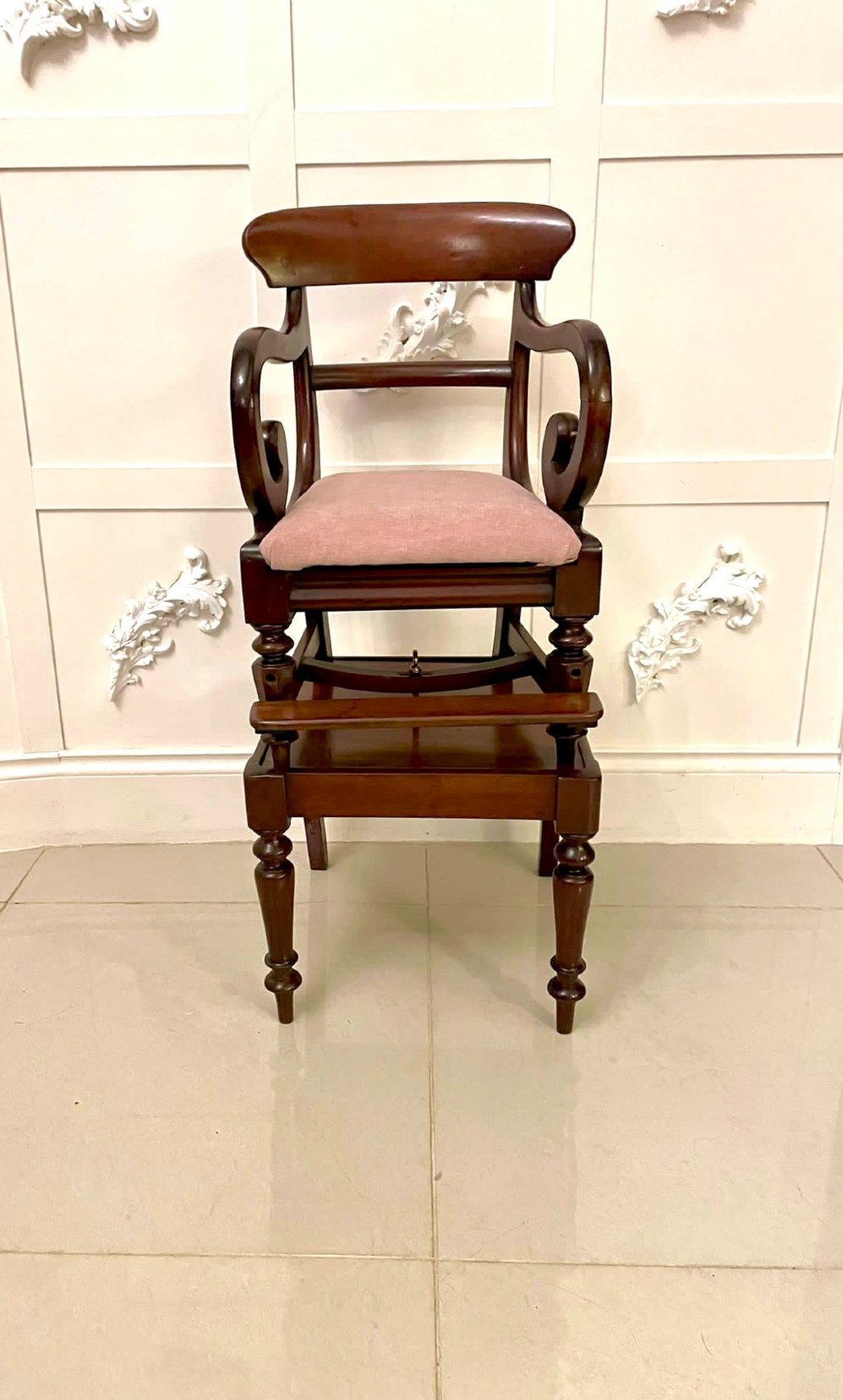 A William IV mahogany childs armchair with scroll arms and a pink upholstered seat, resting on a matching wooden conversion stand. View XIV