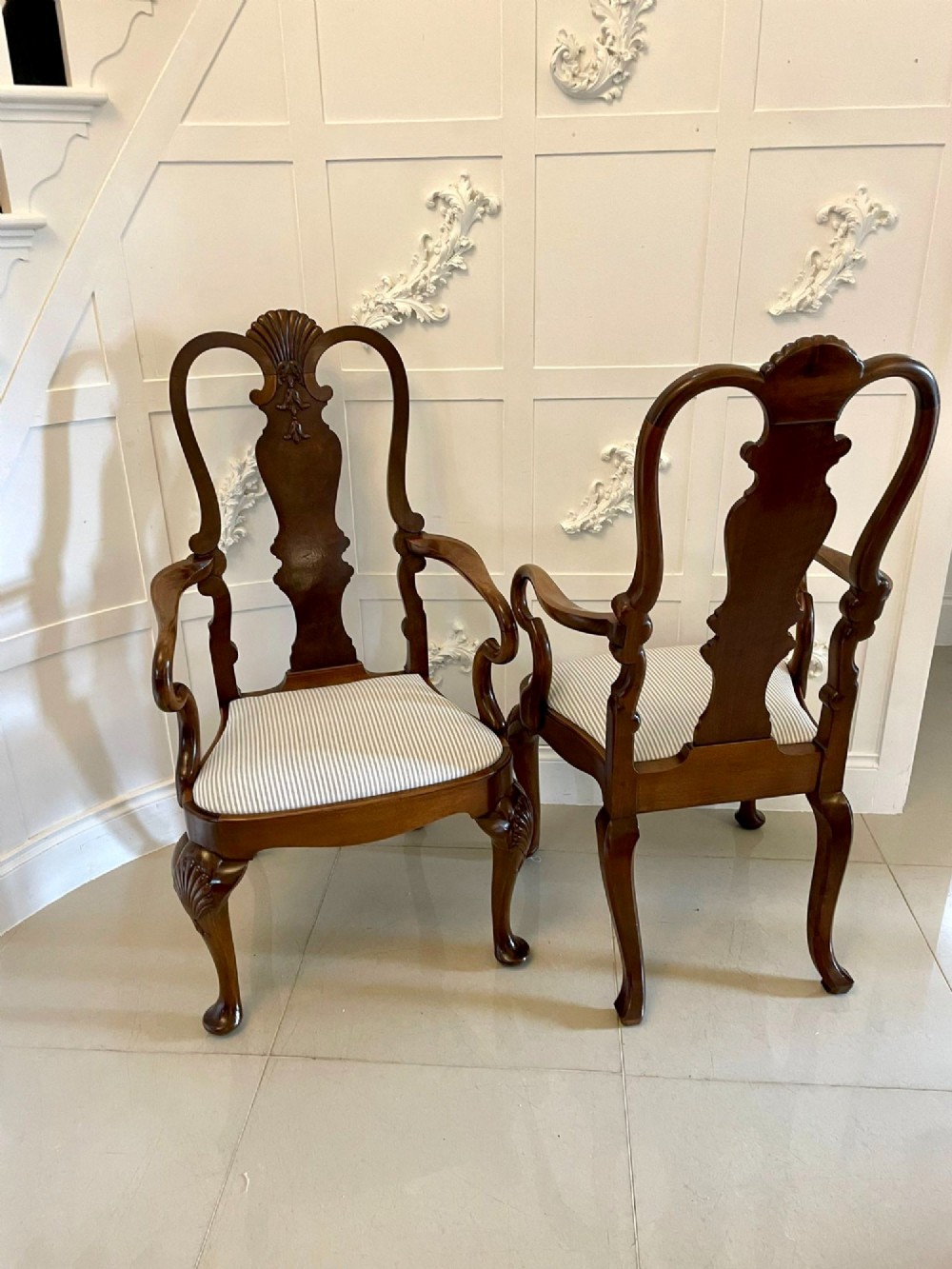 A set of ten walnut dining chairs featuring carved shell crests, splat backs, cabriole legs, and striped upholstered seats. View VIII