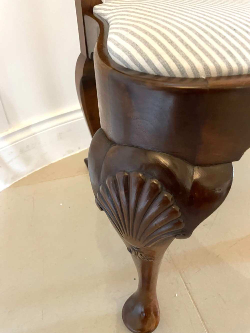 A set of ten walnut dining chairs featuring carved shell crests, splat backs, cabriole legs, and striped upholstered seats. View XI
