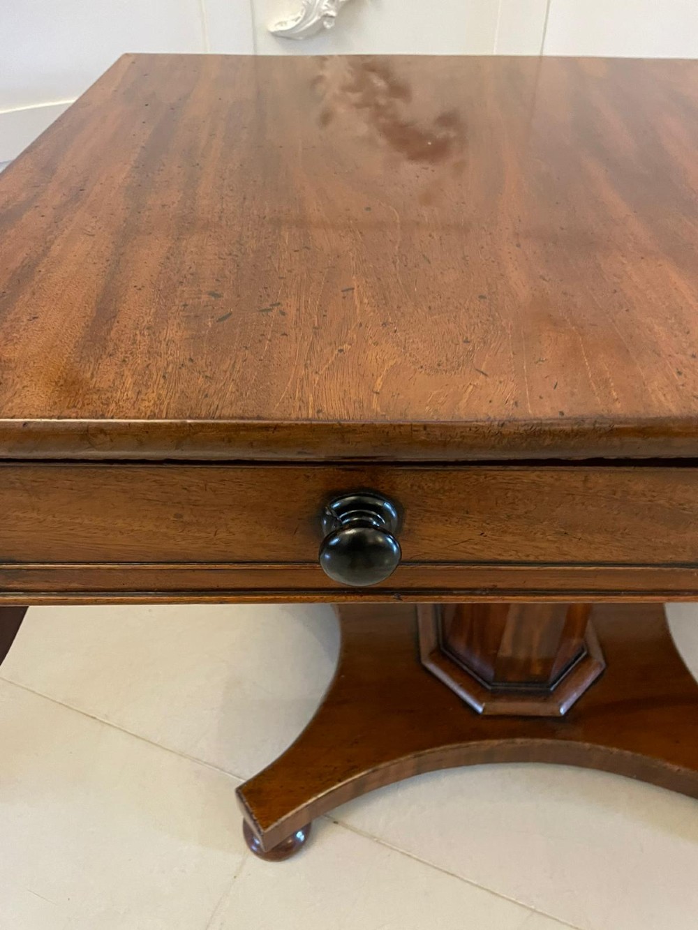 A Regency mahogany sofa table featuring two short drawers with black turned knobs, twin drop-leaf flaps, a central octagonal pedestal, and a quadruped base. View II