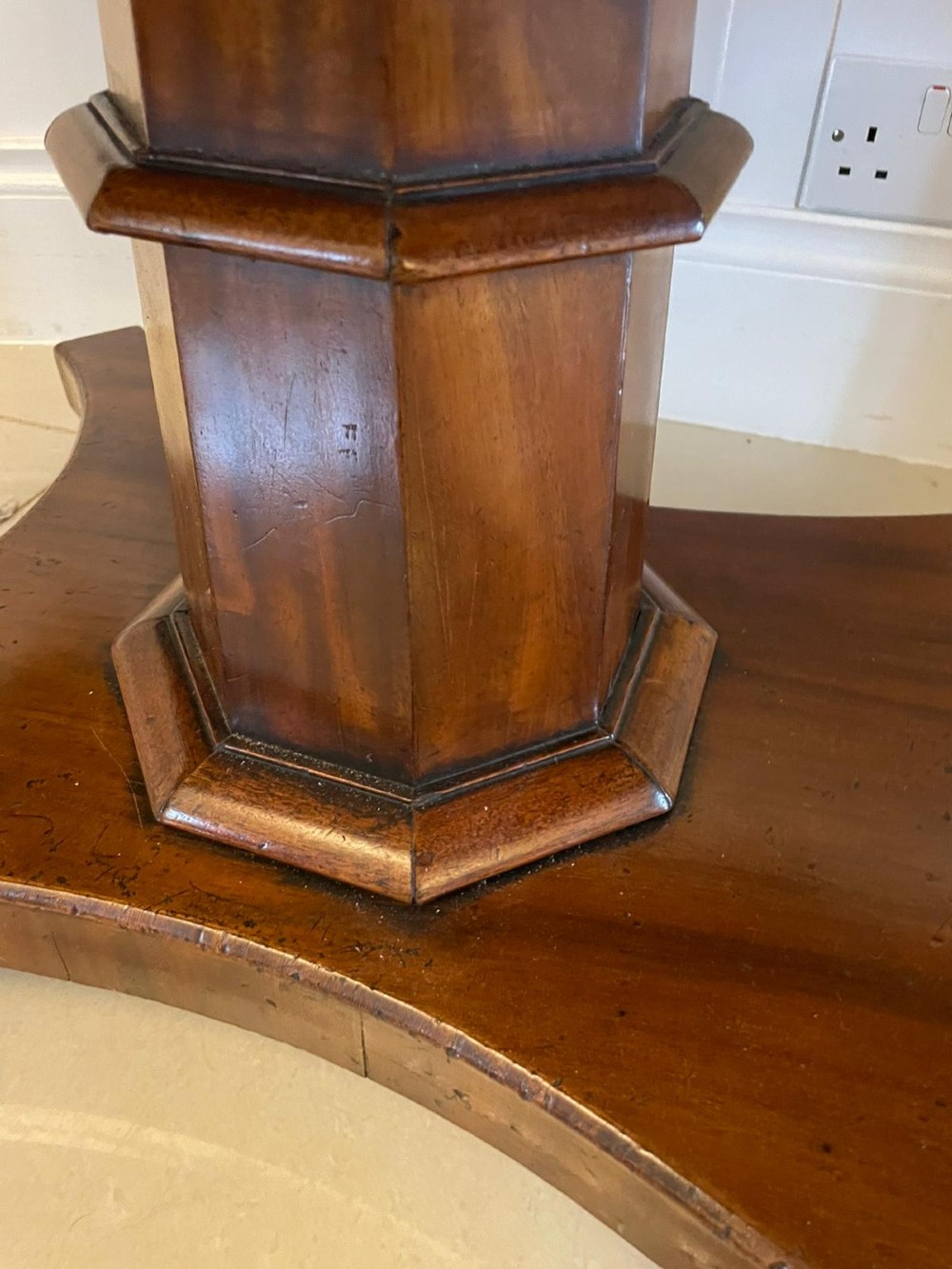 A Regency mahogany sofa table featuring two short drawers with black turned knobs, twin drop-leaf flaps, a central octagonal pedestal, and a quadruped base. View III