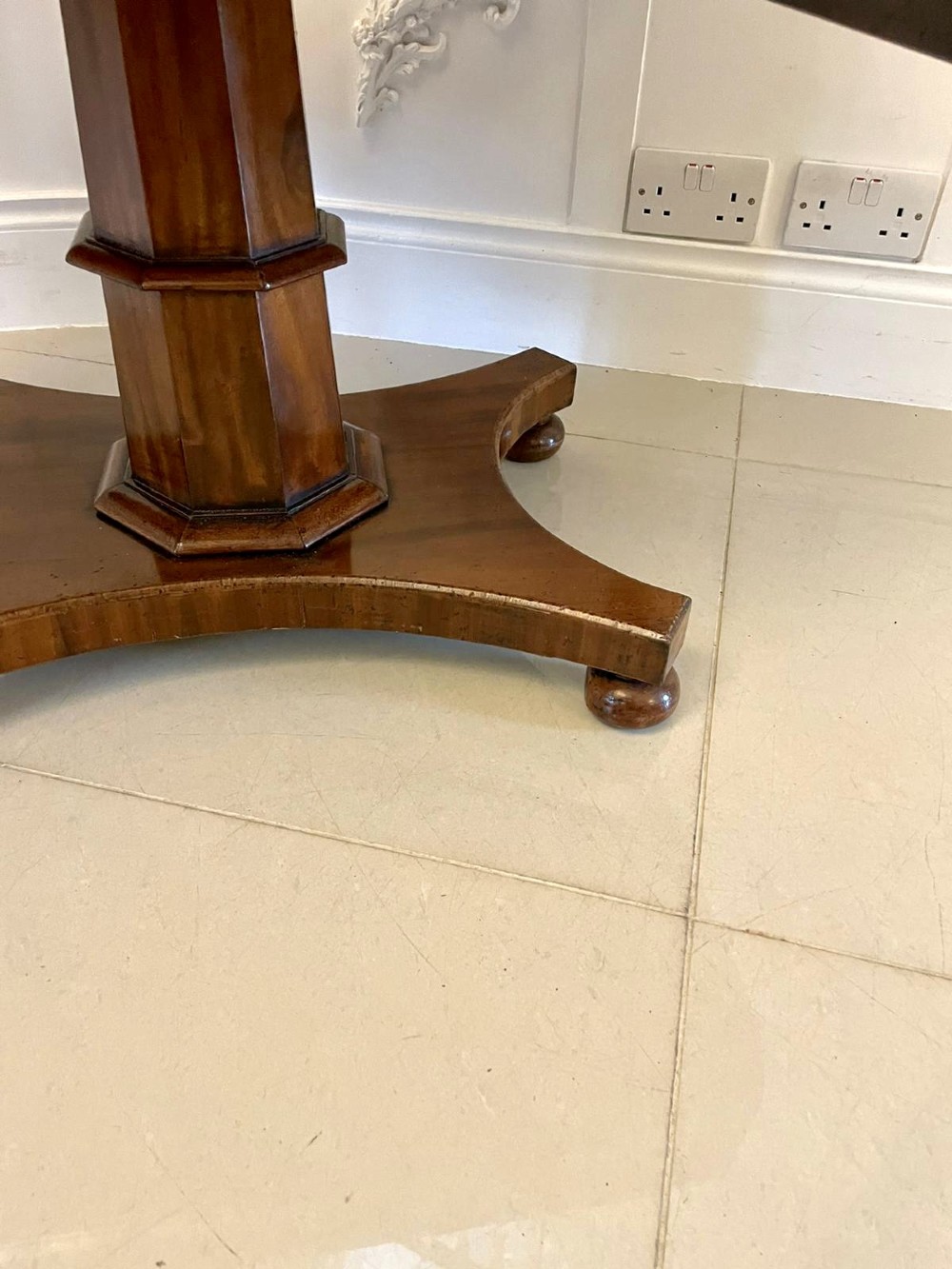 A Regency mahogany sofa table featuring two short drawers with black turned knobs, twin drop-leaf flaps, a central octagonal pedestal, and a quadruped base. View XI