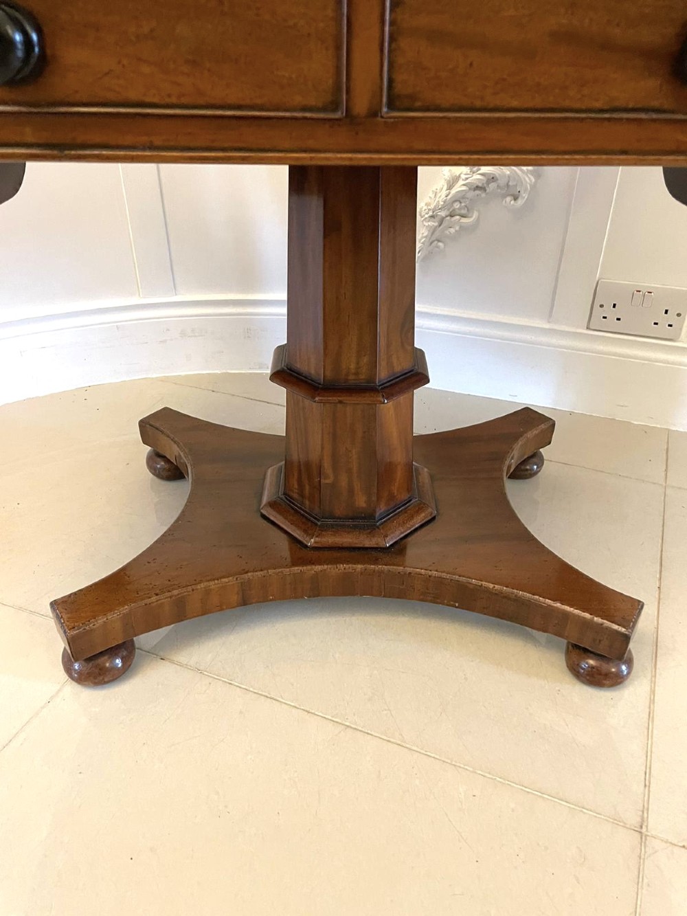 A Regency mahogany sofa table featuring two short drawers with black turned knobs, twin drop-leaf flaps, a central octagonal pedestal, and a quadruped base. View XII