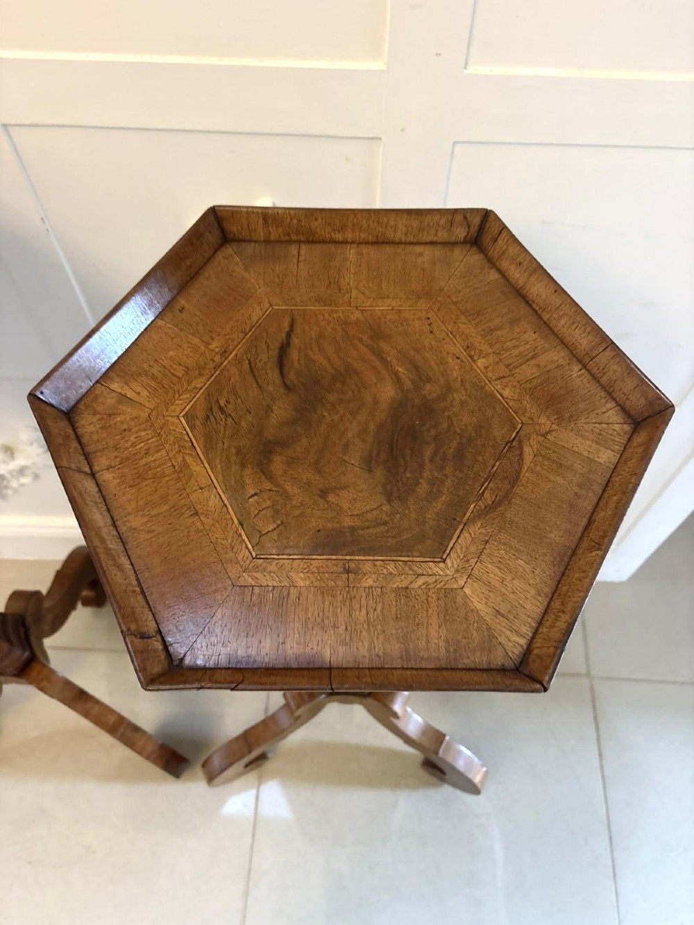 A pair of tall antique Dutch walnut and kingwood pedestal torcheres with molded hexagonal tops and scroll tripod feet. View VII