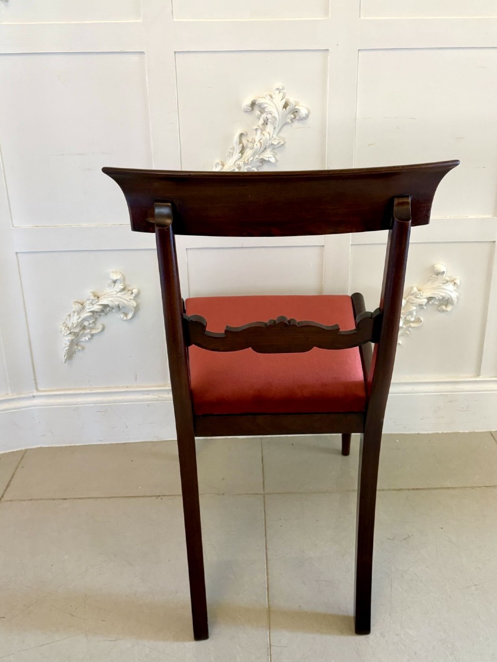 A set of eight Regency mahogany dining chairs featuring two carver armchairs and six side chairs with red upholstered seats. View VI