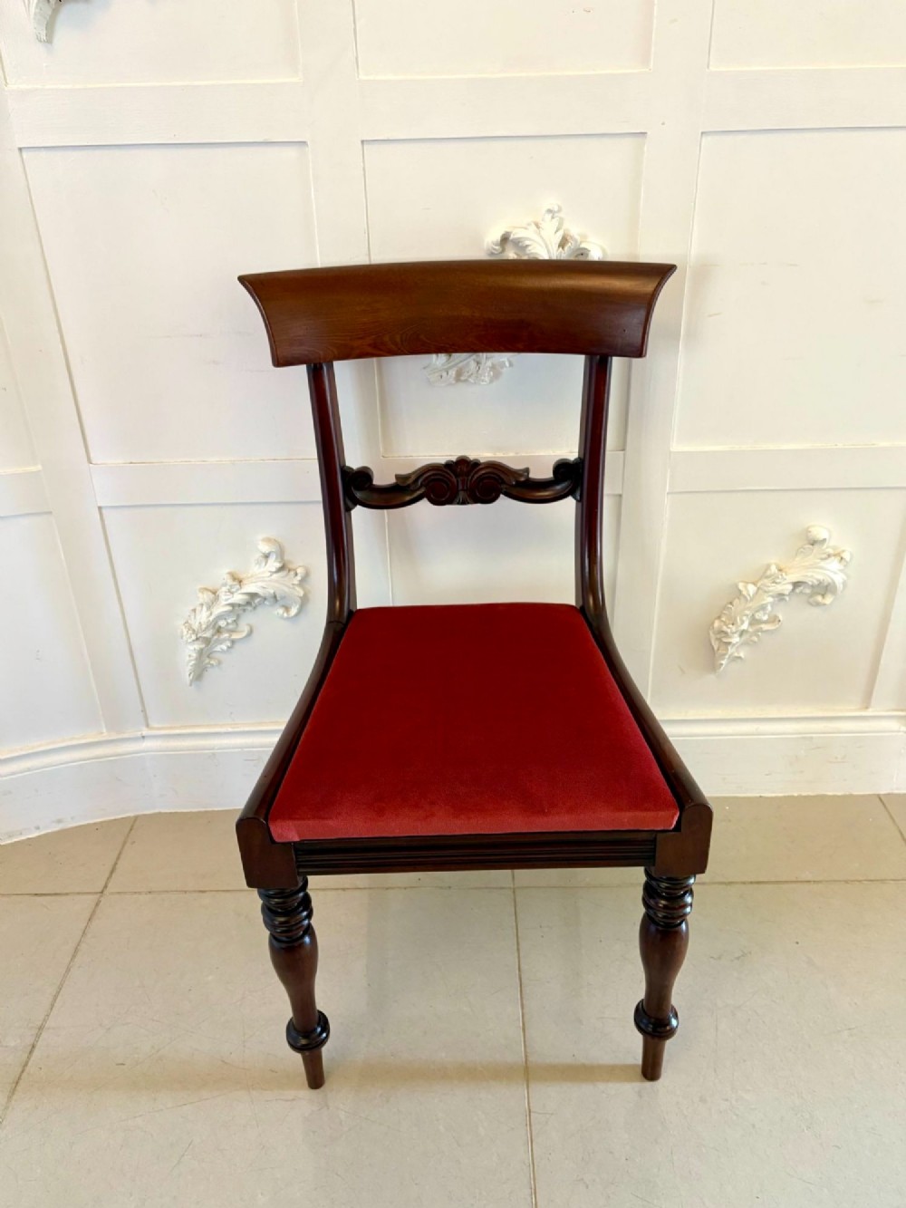 A set of eight Regency mahogany dining chairs featuring two carver armchairs and six side chairs with red upholstered seats. View VIII