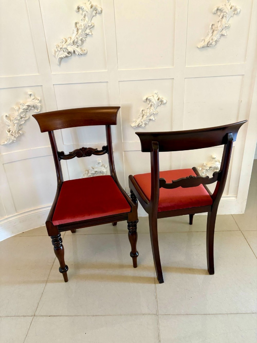 A set of eight Regency mahogany dining chairs featuring two carver armchairs and six side chairs with red upholstered seats. View IX