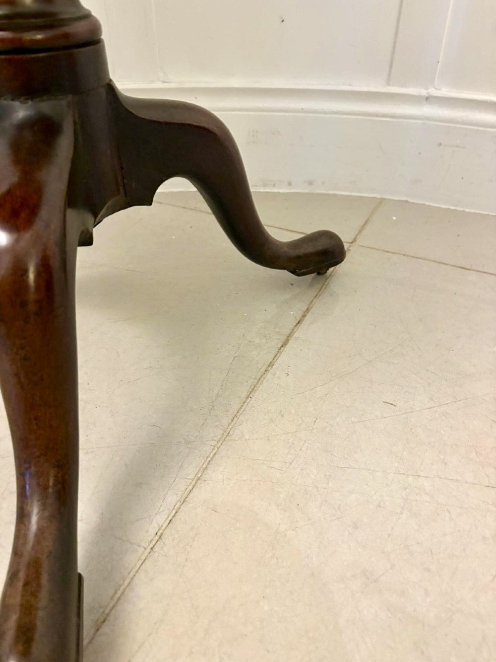 An 18th-century mahogany Chippendale tilt-top tripod table shown upright with a scalloped piecrust edge, turned column, and three cabriole legs. View VI
