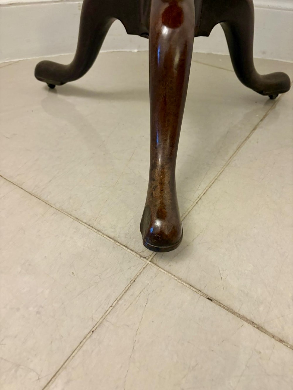 An 18th-century mahogany Chippendale tilt-top tripod table shown upright with a scalloped piecrust edge, turned column, and three cabriole legs. View VII