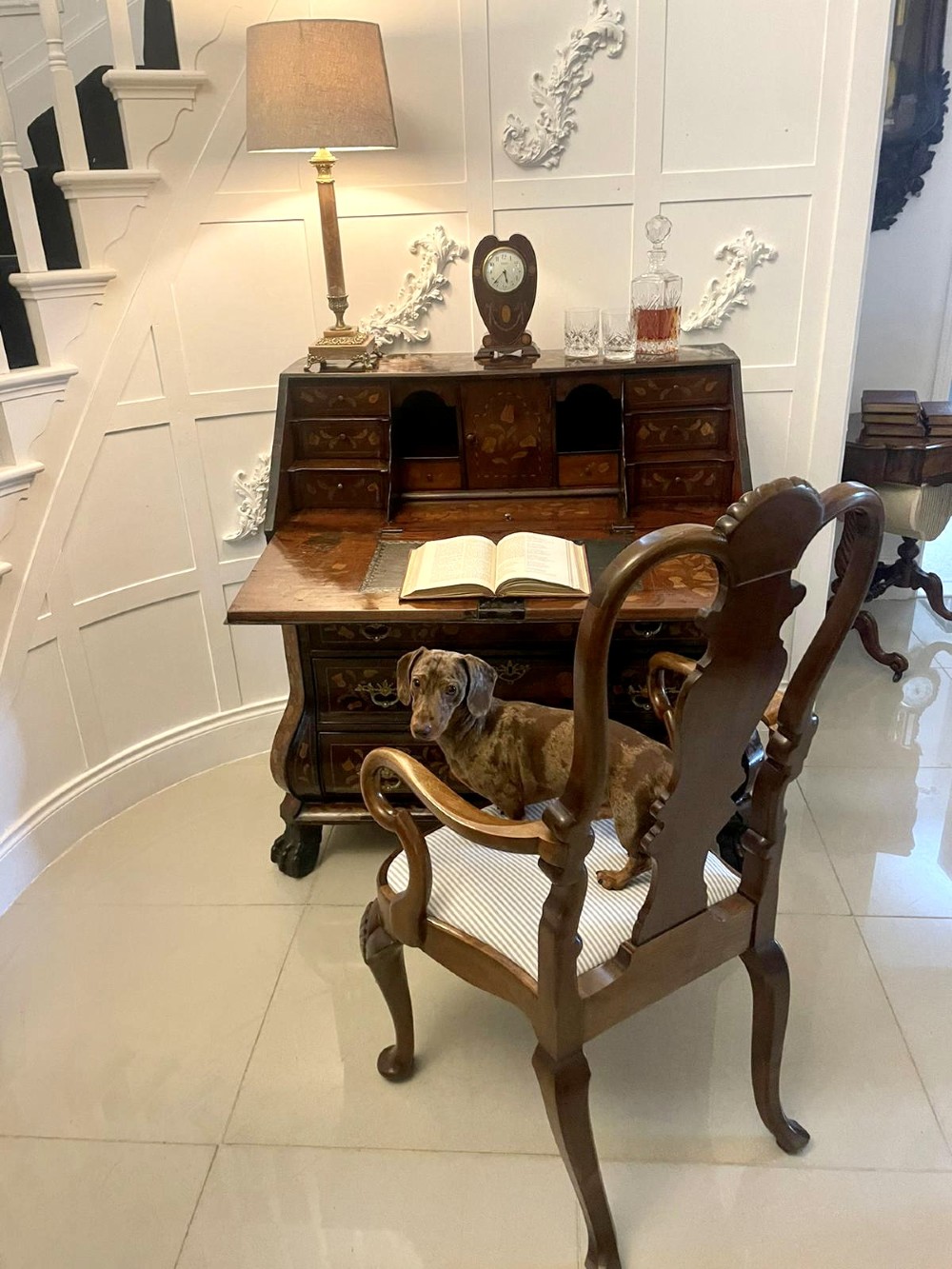 An 18th-century style mahogany bombe bureau featuring floral marquetry inlay across the slant front and drawers, complete with brass handles and carved claw feet. View III