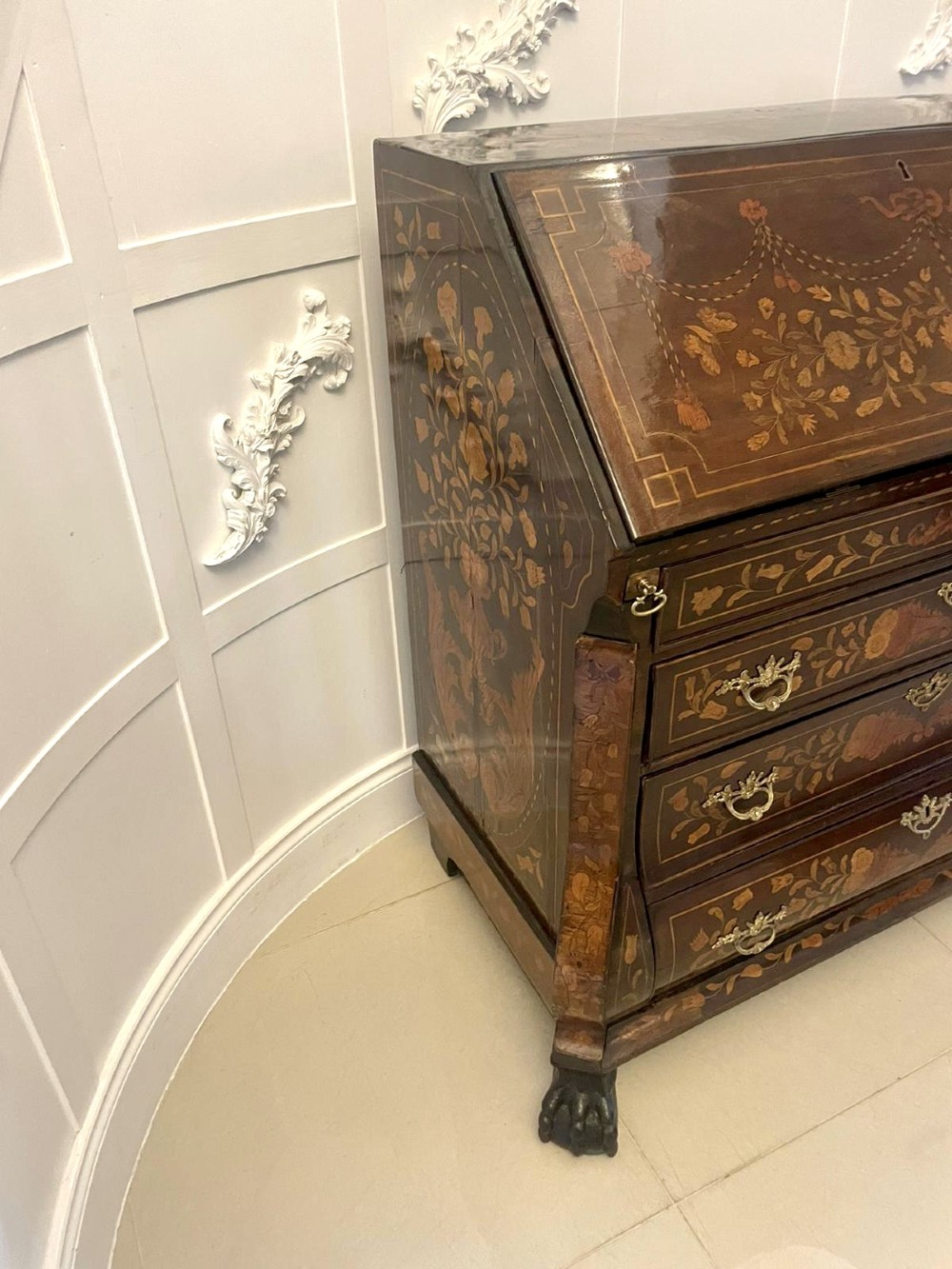 An 18th-century style mahogany bombe bureau featuring floral marquetry inlay across the slant front and drawers, complete with brass handles and carved claw feet. View XII