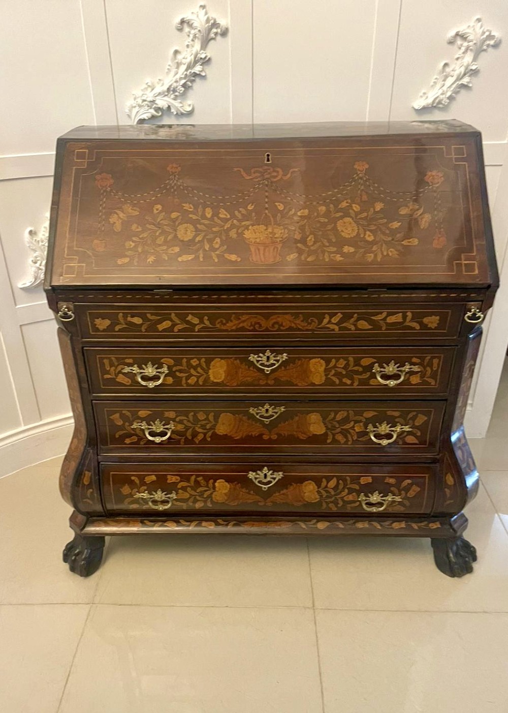 An 18th-century style mahogany bombe bureau featuring floral marquetry inlay across the slant front and drawers, complete with brass handles and carved claw feet. View XV