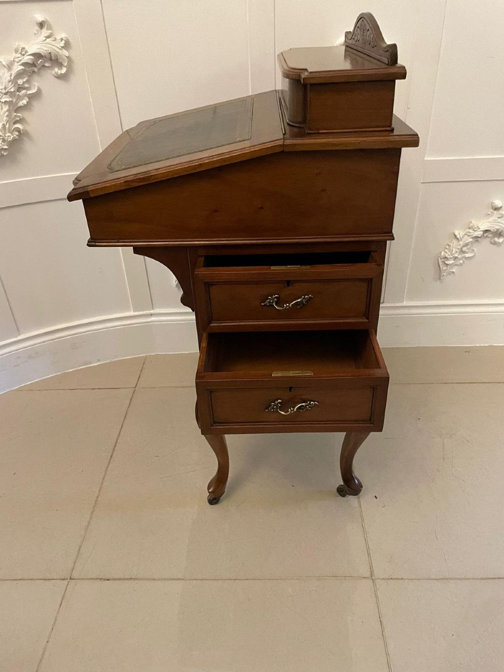 A Victorian walnut Davenport desk featuring a green leather writing slope, an upper stationery box, and carved cabriole legs on castors. View II