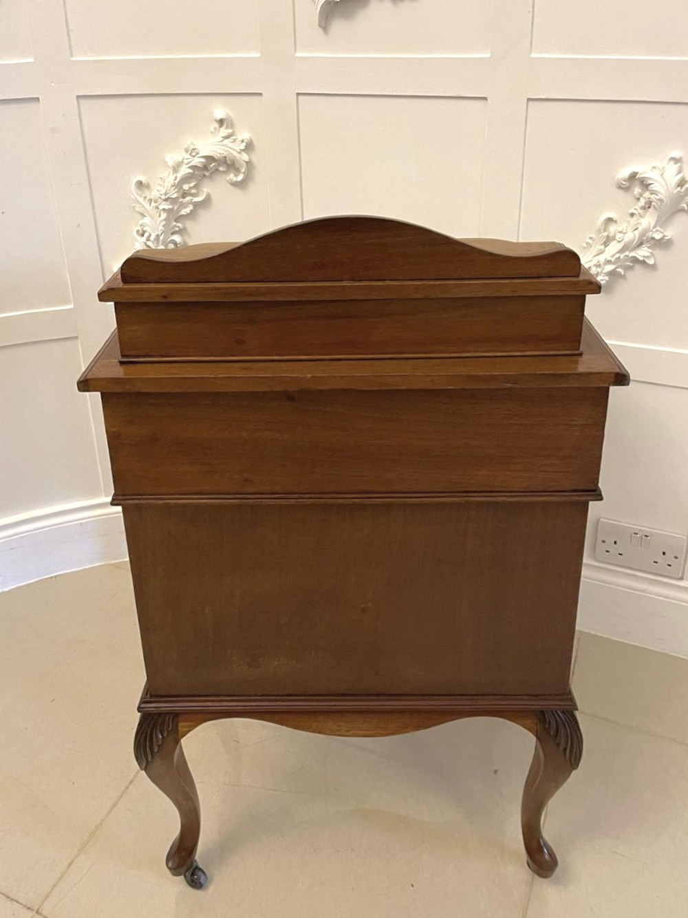 A Victorian walnut Davenport desk featuring a green leather writing slope, an upper stationery box, and carved cabriole legs on castors. View VI