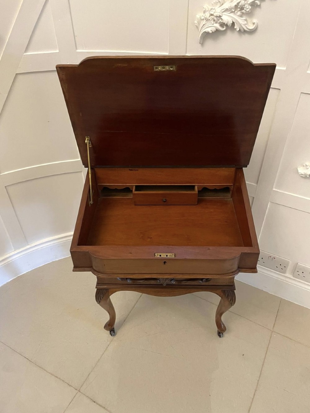 A Victorian walnut Davenport desk featuring a green leather writing slope, an upper stationery box, and carved cabriole legs on castors. View X