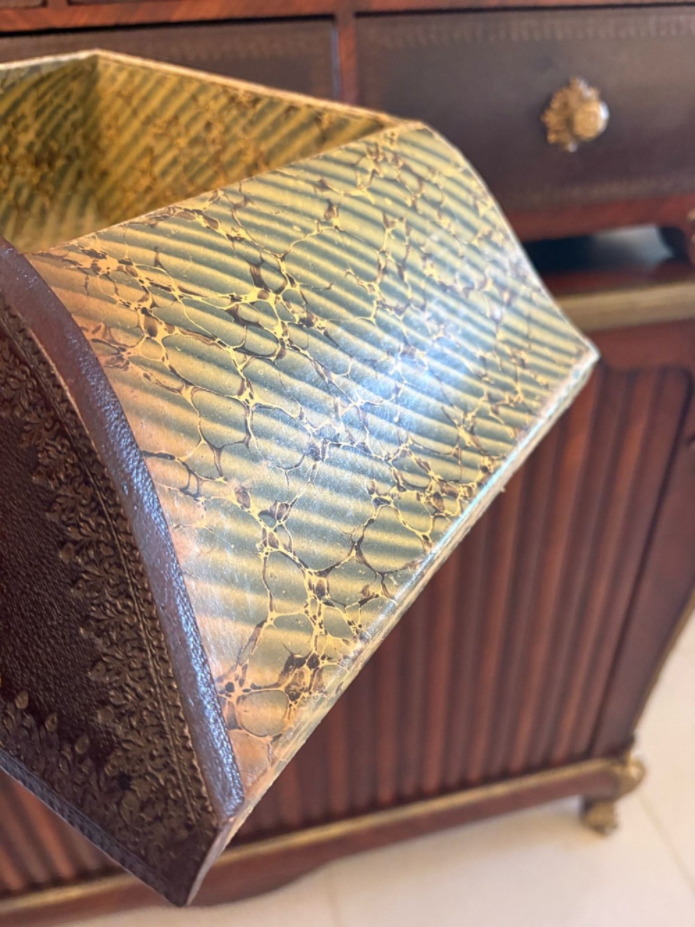 A nineteenth-century French kingwood cartonnier cabinet with leather-faced document drawers and gilded bronze mounts above a fluted cupboard base. View II